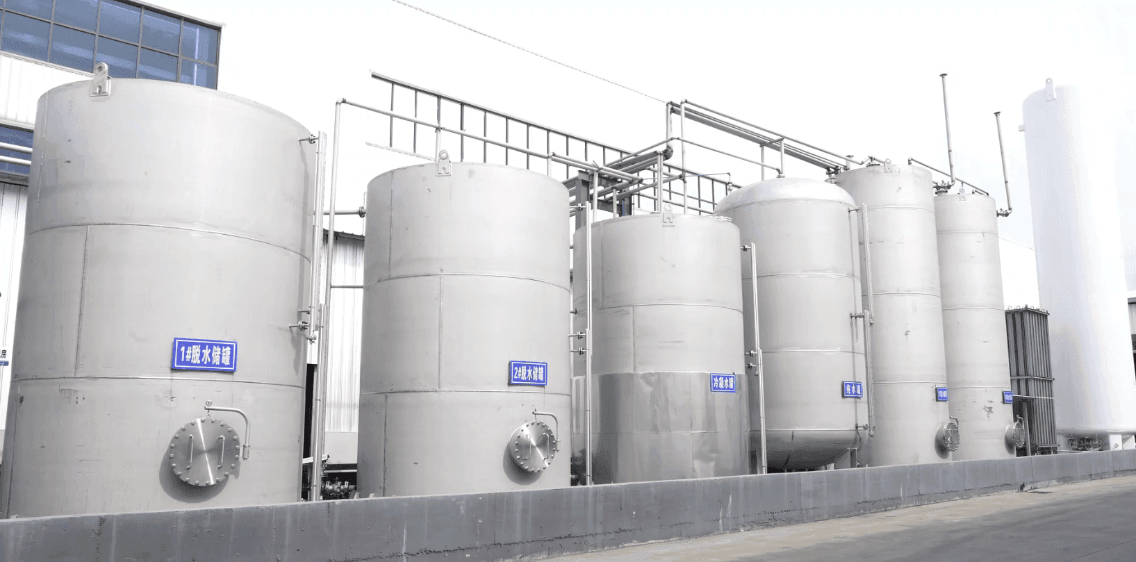 Wide view of the automated plant interior with centrifuges, conveyors, and continuous process equipment.