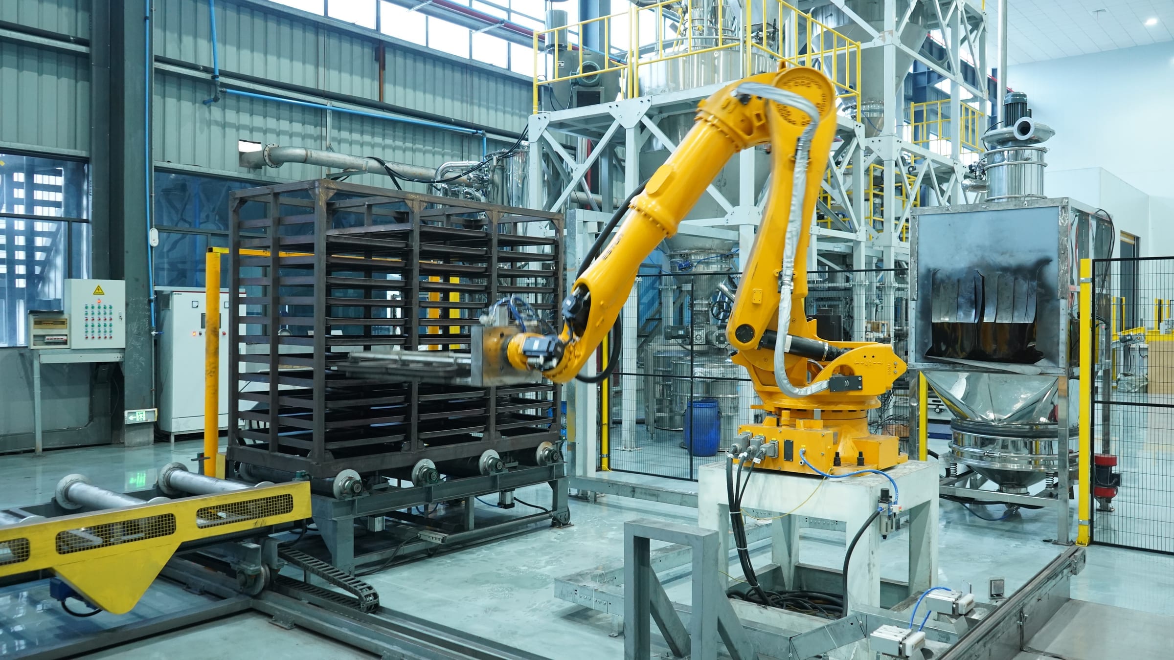 Automated factory floor with copper wire coils and blue production machinery.